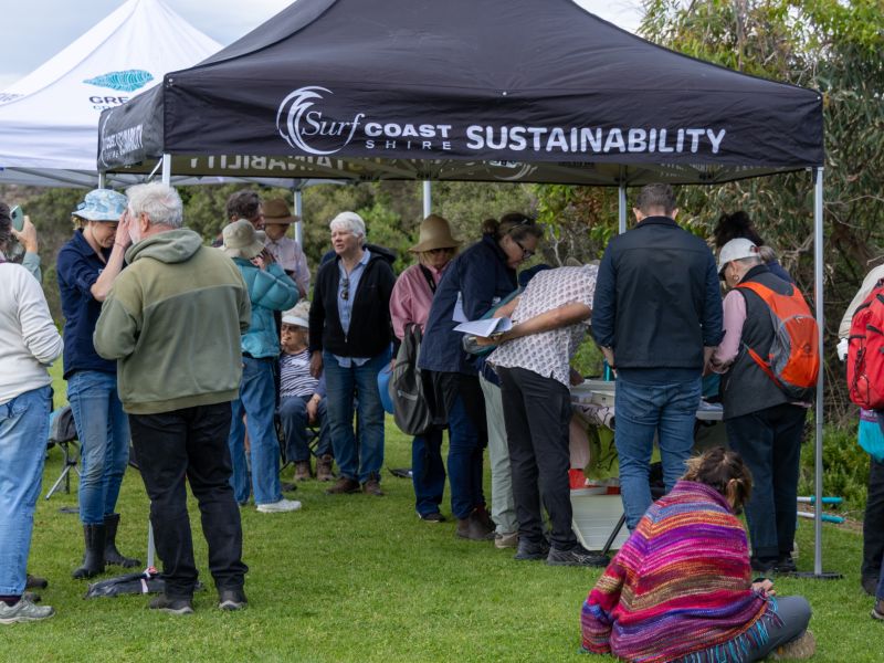 A group of people standing at a surf coast shire marquee