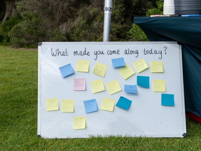 Sign with post it notes on it where people have written why they atteneded the day