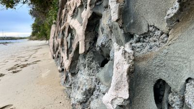 Close up of seawall with sections missing
